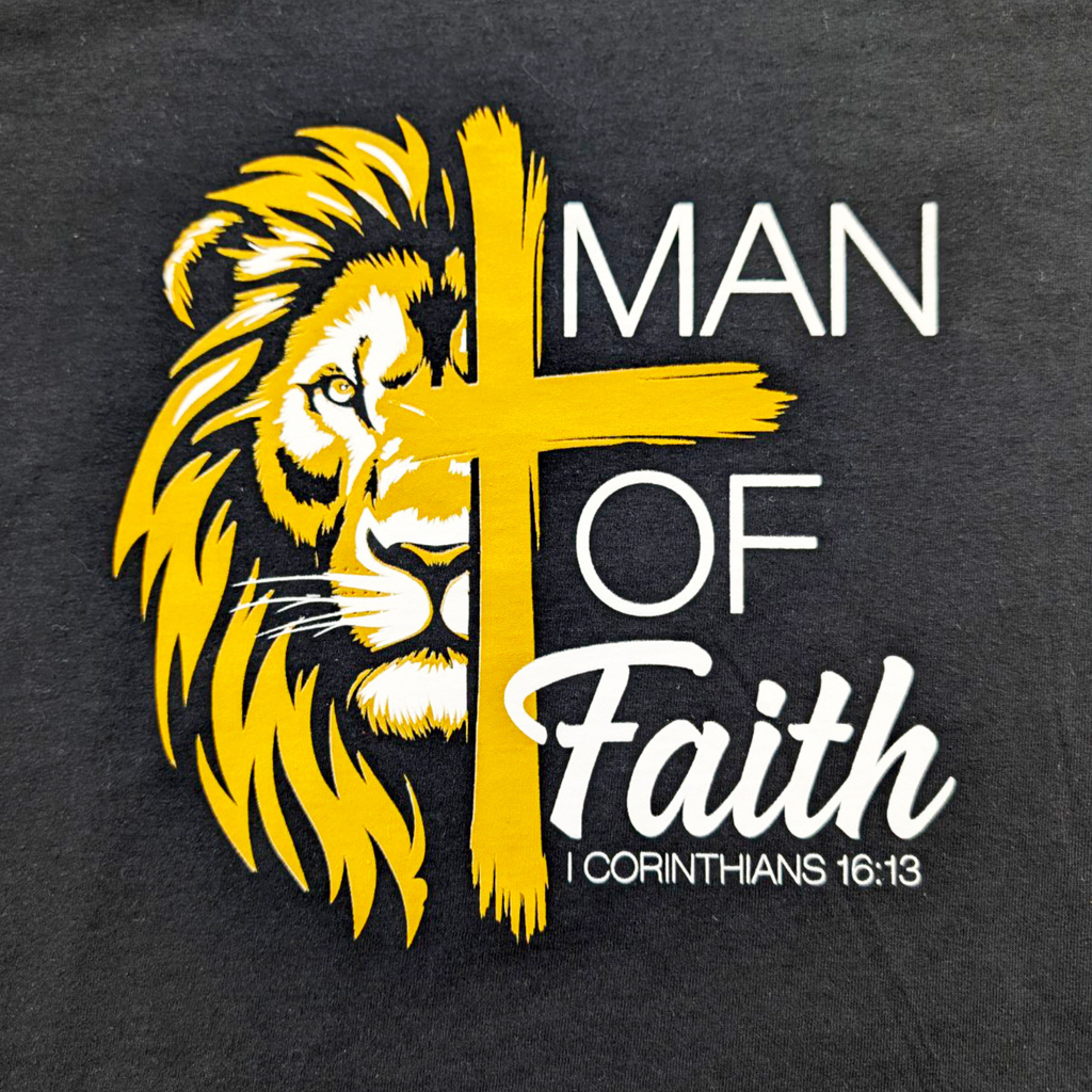 Black t-shirt with yellow lion and cross design and 'Man of Faith' text on a dark background