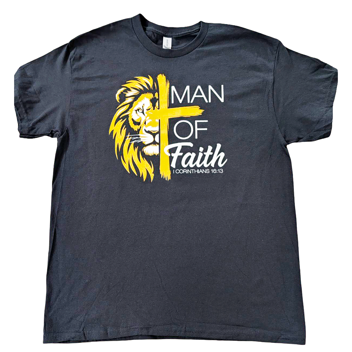 Black t-shirt with yellow lion graphic and cross, featuring text 'Man of Faith 1 Corinthians 16:13' on a white background.